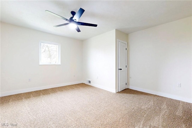 spare room featuring visible vents, carpet flooring, and baseboards