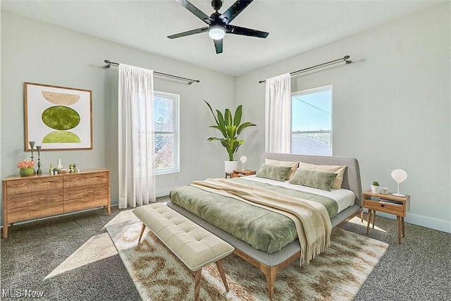 carpeted bedroom featuring a ceiling fan and baseboards