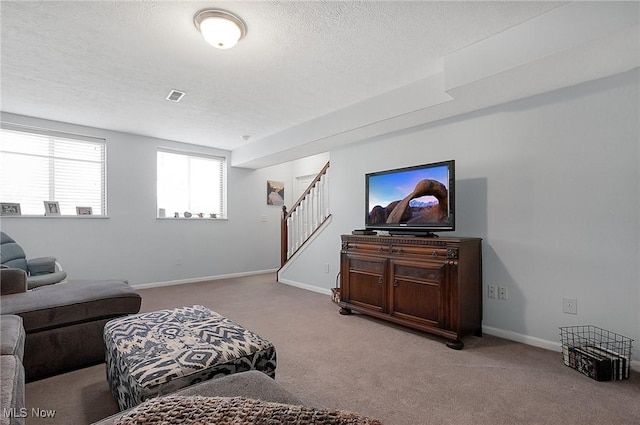 living room featuring a textured ceiling, baseboards, visible vents, stairway, and carpet floors