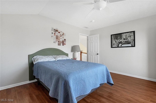 bedroom with wood finished floors, baseboards, vaulted ceiling, and a ceiling fan