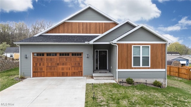 1804 28th St, Vienna, WV 26105 - view of front of house with concrete driveway, fence, a front yard, and a garage