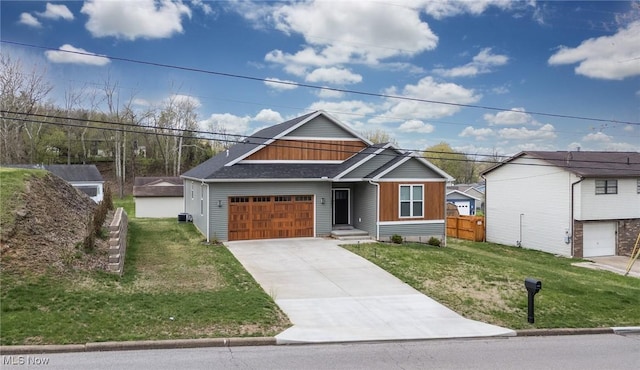 1804 28th St, Vienna, WV 26105 - craftsman inspired home with roof with shingles, concrete driveway, fence, an attached garage, and a front yard