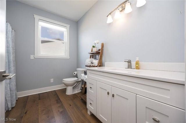 1804 28th St, Vienna, WV 26105 - bathroom featuring baseboards, wood finished floors, toilet, and vanity