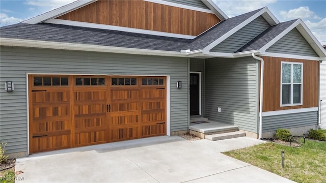 1804 28th St, Vienna, WV 26105 - entrance to property featuring an attached garage, a shingled roof, and driveway