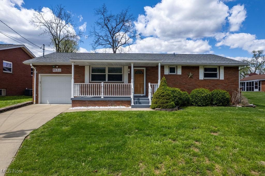 813 14th Ave, Vienna, WV 26105 - single story home featuring a garage, concrete driveway, a porch, a front yard, and brick siding