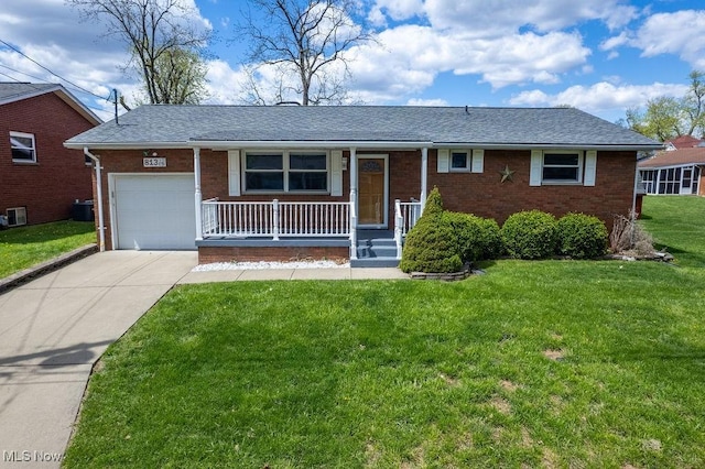 single story home with a front lawn, covered porch, brick siding, and a garage