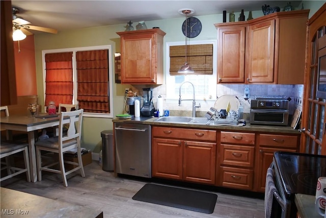 kitchen with light wood finished floors, stainless steel dishwasher, a sink, ceiling fan, and electric range oven