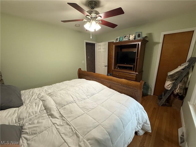 bedroom featuring wood finished floors and ceiling fan