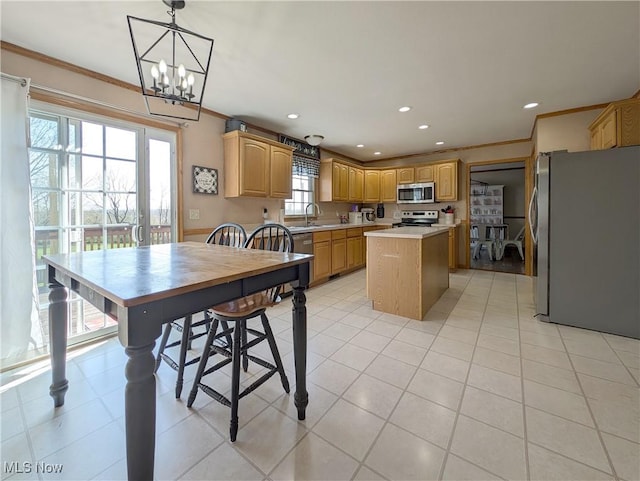 kitchen featuring crown molding, stainless steel appliances, a kitchen island, light countertops, and recessed lighting