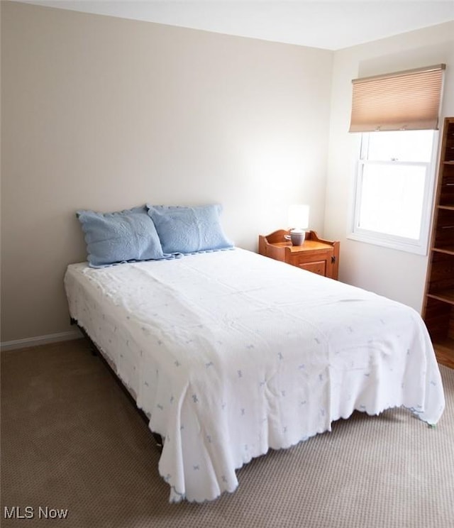 carpeted bedroom featuring baseboards