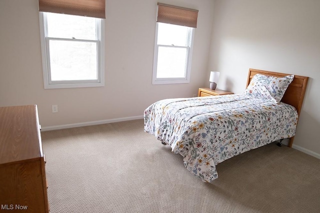 carpeted bedroom with baseboards