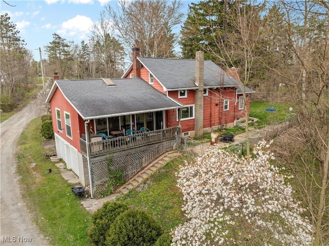 1611 Township Road 1610, Ashland, OH 44805 - rear view of house with a porch, a shingled roof, a chimney, and a garage