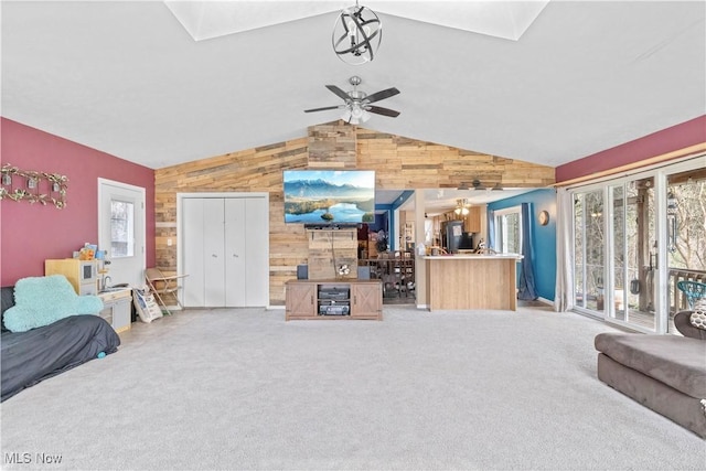 1611 Township Road 1610, Ashland, OH 44805 - living area with light colored carpet, ceiling fan, wood walls, and lofted ceiling with skylight