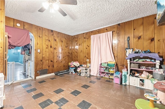 1611 Township Road 1610, Ashland, OH 44805 - interior space with a ceiling fan, a textured ceiling, wooden walls, and tile patterned floors