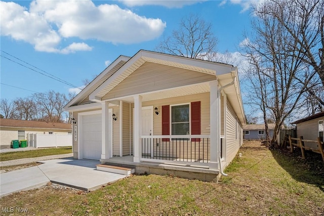 502 Fairlawn Ave, Painesville, OH 44077 - view of front facade with concrete driveway, a front yard, a garage, fence, and covered porch