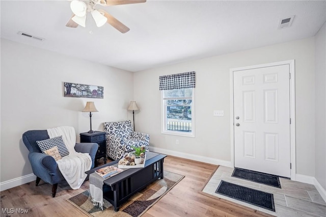 502 Fairlawn Ave, Painesville, OH 44077 - living room with visible vents, baseboards, ceiling fan, and light wood-style floors