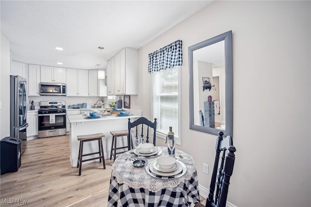 502 Fairlawn Ave, Painesville, OH 44077 - dining space featuring recessed lighting, light wood finished floors, and baseboards
