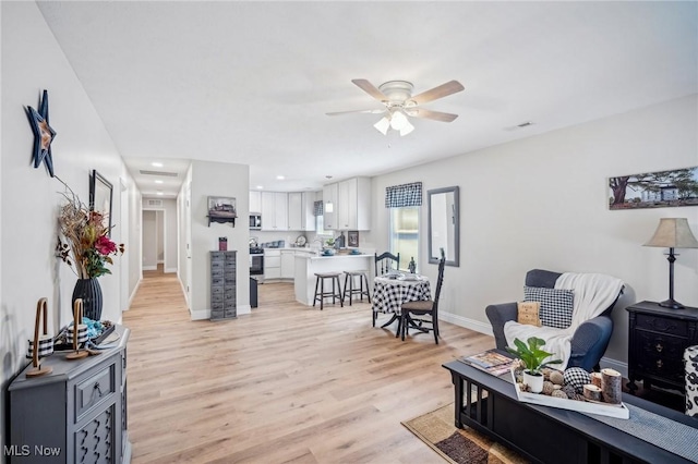 502 Fairlawn Ave, Painesville, OH 44077 - living room with visible vents, baseboards, a ceiling fan, light wood-style floors, and recessed lighting