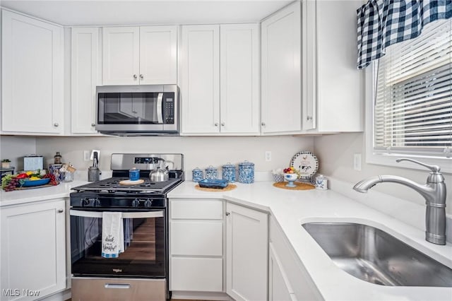 502 Fairlawn Ave, Painesville, OH 44077 - kitchen with light countertops, appliances with stainless steel finishes, a sink, and white cabinets