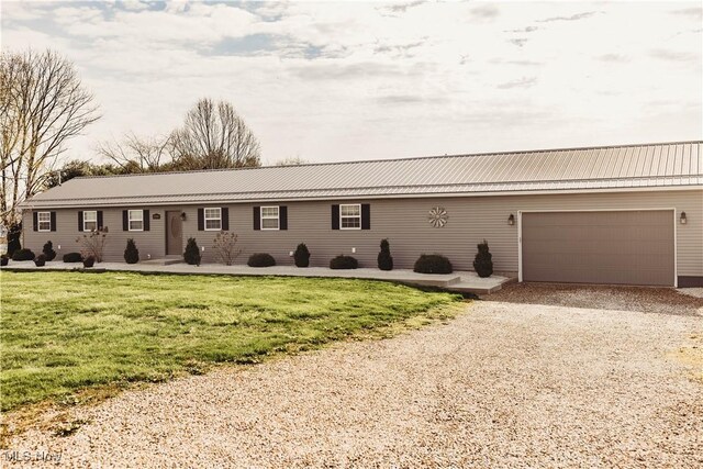 25900 Township Road 26, Coshocton, OH 43812 - single story home featuring gravel driveway, a front lawn, an attached garage, and metal roof