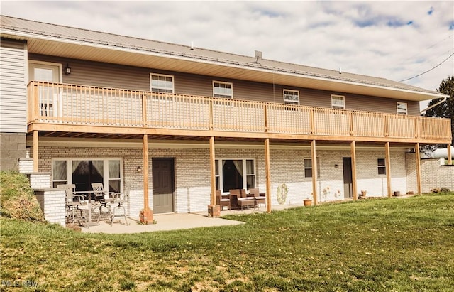 25900 Township Road 26, Coshocton, OH 43812 - rear view of property with a patio area, a deck, a yard, metal roof, and brick siding