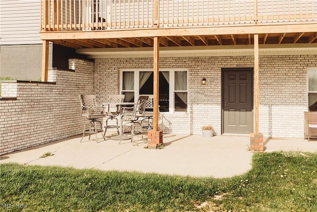 25900 Township Road 26, Coshocton, OH 43812 - doorway to property with a patio area, a balcony, and brick siding