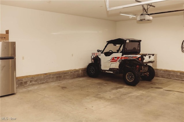 25900 Township Road 26, Coshocton, OH 43812 - garage with freestanding refrigerator and a garage door opener