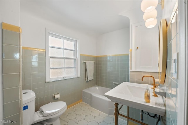 14221 S Woodland Rd, Shaker Heights, OH 44120 - full bathroom with tile walls, tile patterned floors, toilet, and a bath