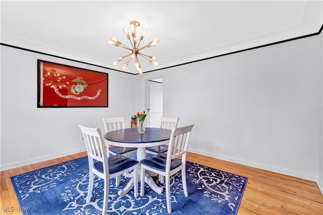 14221 S Woodland Rd, Shaker Heights, OH 44120 - dining space featuring a chandelier, baseboards, and wood finished floors
