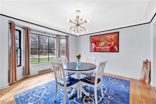 14221 S Woodland Rd, Shaker Heights, OH 44120 - dining space featuring a chandelier, visible vents, light wood finished floors, and baseboards