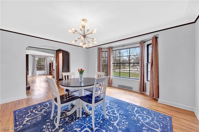 14221 S Woodland Rd, Shaker Heights, OH 44120 - dining area featuring an inviting chandelier, a healthy amount of sunlight, visible vents, and arched walkways