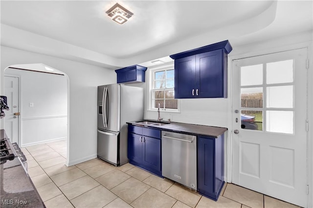 14221 S Woodland Rd, Shaker Heights, OH 44120 - kitchen with a sink, appliances with stainless steel finishes, dark countertops, arched walkways, and blue cabinetry