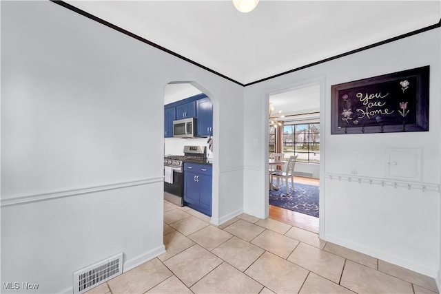 14221 S Woodland Rd, Shaker Heights, OH 44120 - hall featuring light tile patterned floors, visible vents, arched walkways, an inviting chandelier, and baseboards
