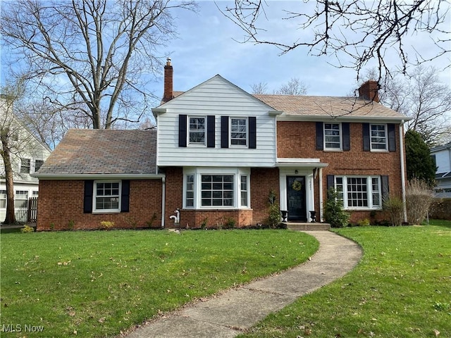 14221 S Woodland Rd, Shaker Heights, OH 44120 - view of front of property featuring a chimney, a front yard, and brick siding