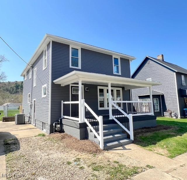 view of front facade featuring covered porch and central AC unit
