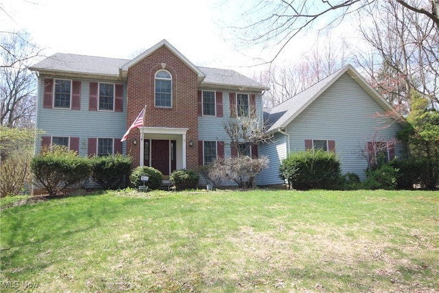 colonial house with brick siding and a front yard