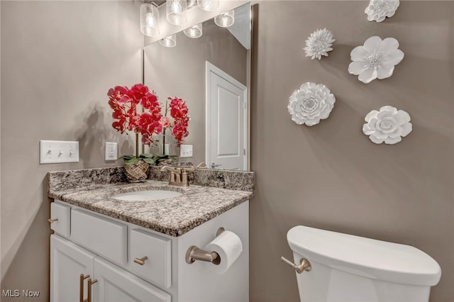 half bathroom featuring toilet and vanity