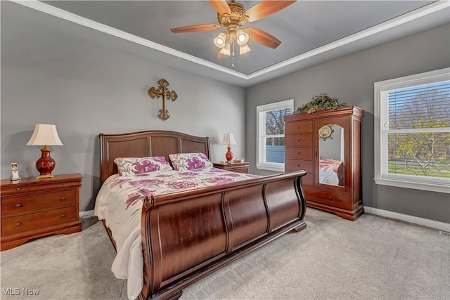 bedroom featuring a ceiling fan, baseboards, a raised ceiling, and light colored carpet