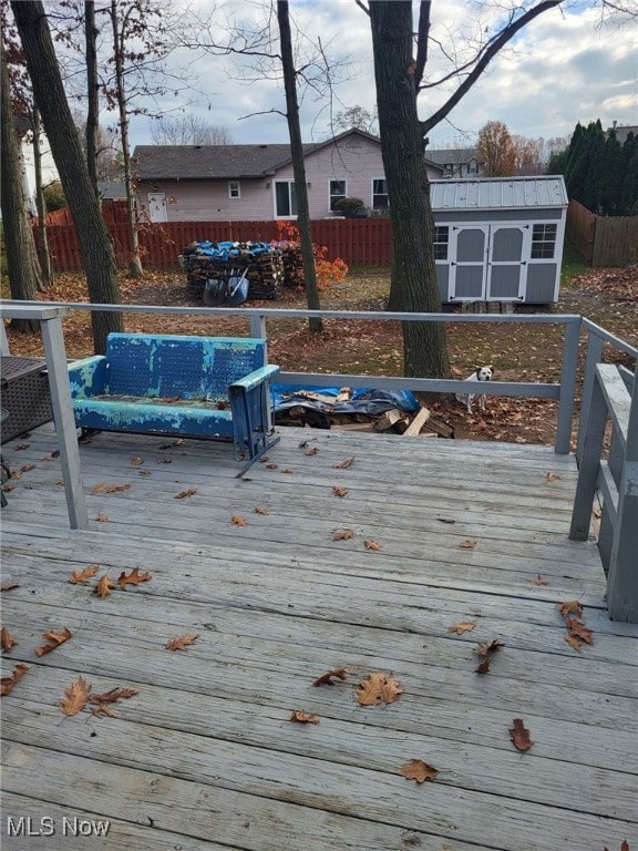 1239 Woodledge Dr, Mineral Ridge, OH 44440 - deck with a fenced backyard, an outdoor structure, and a shed