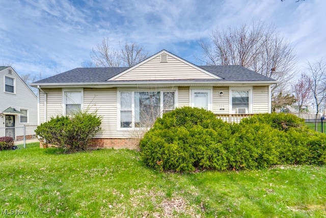 bungalow-style house with a front lawn, fence, and roof with shingles