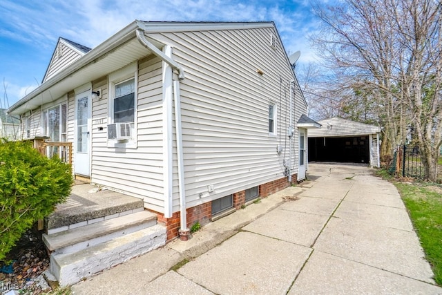 view of property exterior featuring fence, cooling unit, and a garage