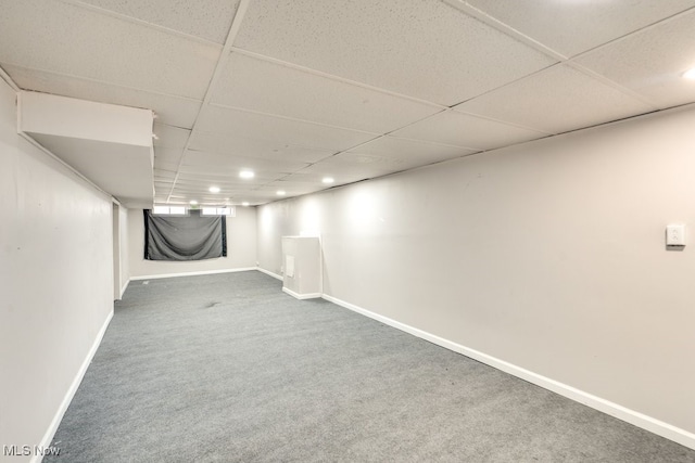 finished below grade area featuring recessed lighting, carpet flooring, a drop ceiling, and baseboards