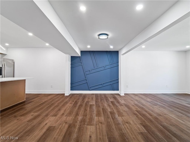 interior space with baseboards, recessed lighting, and dark wood-style flooring