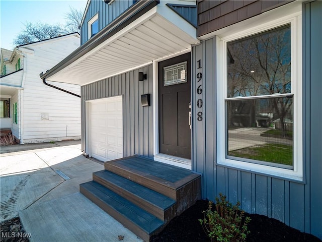 property entrance with board and batten siding and a garage