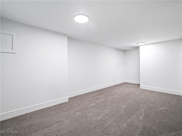 finished below grade area featuring baseboards and carpet