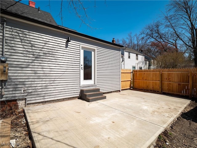 back of property featuring fence, a patio area, and entry steps
