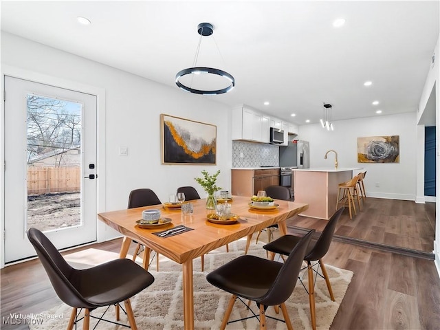 dining area with recessed lighting, wood finished floors, and baseboards