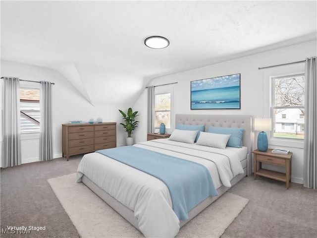 carpeted bedroom featuring vaulted ceiling and baseboards