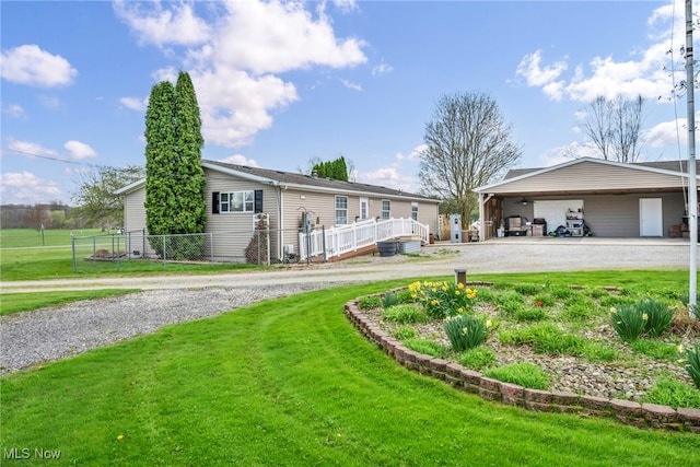 single story home featuring driveway, fence, an attached carport, and a front yard