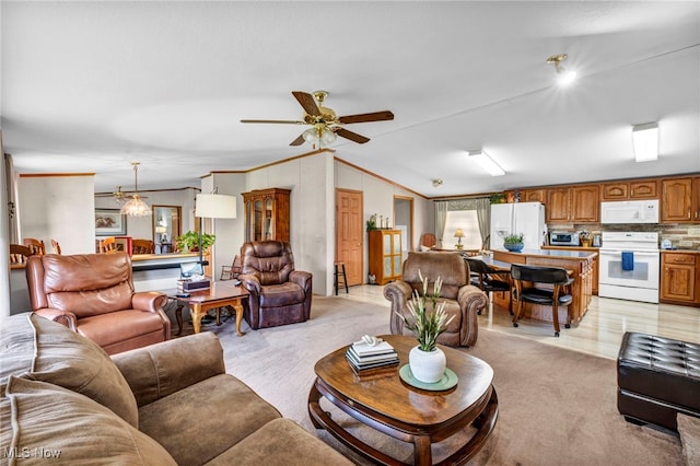 living area featuring light colored carpet, lofted ceiling, and crown molding